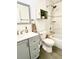 Bathroom with vanity, toilet, mirror, tiled shower, and white tile walls at 3315 W Saint John St, Tampa, FL 33607
