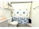This bathroom features a floral shower curtain, toilet, and tiled shower walls at 3315 W Saint John St, Tampa, FL 33607