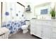 Bathroom with a modern white vanity, framed mirror, toilet, and shower with a decorative curtain at 3315 W Saint John St, Tampa, FL 33607
