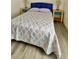 Bedroom featuring a blue headboard and yellow nightstands with a gray and white floral quilt at 3315 W Saint John St, Tampa, FL 33607