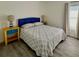 Cozy bedroom with blue headboard, patterned quilt, and yellow bedside tables with lamps at 3315 W Saint John St, Tampa, FL 33607