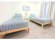 Light bedroom with 2 twin beds, matching side tables, wood frames and light walls at 3315 W Saint John St, Tampa, FL 33607