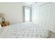 Light bedroom with a comfortable bed, colorful bedside table with nautical lamp, and closet at 3315 W Saint John St, Tampa, FL 33607