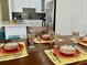 Cozy dining area table setting with colorful dishware and silverware at 3315 W Saint John St, Tampa, FL 33607