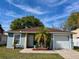 Charming single-story home featuring a well-maintained lawn, attached garage, and a welcoming front entrance at 3315 W Saint John St, Tampa, FL 33607