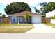 Attractive single-Gathering home with a driveway, garage, palm tree, and well-kept lawn at 3315 W Saint John St, Tampa, FL 33607