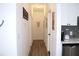 Hallway view leading to kitchen with white cabinets and gray backsplash at 3315 W Saint John St, Tampa, FL 33607