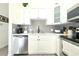 Modern kitchen features white cabinets, stainless steel appliances, and sleek countertops at 3315 W Saint John St, Tampa, FL 33607