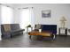 Stylish living room with eclectic decor, featuring gray floors, white walls, and comfortable seating at 3315 W Saint John St, Tampa, FL 33607
