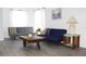 Bright living room with modern decor, featuring gray floors, white walls, and comfortable seating at 3315 W Saint John St, Tampa, FL 33607
