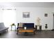 Bright living room with eclectic decor, featuring gray floors, white walls, and stylish seating at 3315 W Saint John St, Tampa, FL 33607