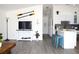 Open-concept living area with modern flooring, sleek furniture, and a bright, airy atmosphere at 3315 W Saint John St, Tampa, FL 33607