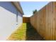 Narrow side yard featuring a new fence at 3315 W Saint John St, Tampa, FL 33607