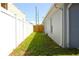Side yard showcasing well-maintained grass and a privacy fence at 3315 W Saint John St, Tampa, FL 33607