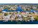 Aerial view of waterfront home with a pool and boat dock situated in a coastal community at 3352 Gulfview Dr, Hernando Beach, FL 34607