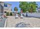 Beautifully paved backyard patio featuring outdoor seating, landscaping, and a white picket fence at 3352 Gulfview Dr, Hernando Beach, FL 34607