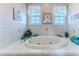 Relaxing bathroom features a large soaking tub, tile surround, and decorative accents at 3352 Gulfview Dr, Hernando Beach, FL 34607