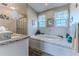 Bright bathroom features a soaking tub, shower, and vanity with lots of storage at 3352 Gulfview Dr, Hernando Beach, FL 34607