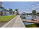 Waterfront property showcasing a private dock with a boat lift on a sunny day at 3352 Gulfview Dr, Hernando Beach, FL 34607