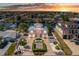 Stunning waterfront home with lush landscaping, brick driveway, and attached garages at sunset at 3352 Gulfview Dr, Hernando Beach, FL 34607