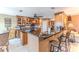 Modern kitchen area with custom wood cabinets, granite countertops, and barstool seating at 3352 Gulfview Dr, Hernando Beach, FL 34607