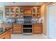 Well-equipped kitchen with stylish cabinetry, granite countertops, stainless steel oven, and tile backsplash at 3352 Gulfview Dr, Hernando Beach, FL 34607