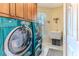Modern laundry room with front load washer and dryer, and wash basin at 3352 Gulfview Dr, Hernando Beach, FL 34607