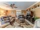 Inviting living room featuring comfortable sofas, stylish decor, and a ceiling fan for added comfort at 3352 Gulfview Dr, Hernando Beach, FL 34607