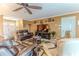 Comfortable living room featuring leather sofas, a ceiling fan, and decorative shelving creating a cozy atmosphere at 3352 Gulfview Dr, Hernando Beach, FL 34607