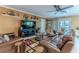 Spacious living room with comfortable leather seating, sliding glass doors, and stylish decor at 3352 Gulfview Dr, Hernando Beach, FL 34607