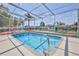 Inviting screened-in pool with clear blue water and decorative tile accents at 3352 Gulfview Dr, Hernando Beach, FL 34607