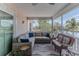 Inviting screened porch featuring comfortable wicker furniture and peaceful waterfront views at 3352 Gulfview Dr, Hernando Beach, FL 34607