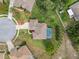 Bird's eye view of a well-manicured property with a pool, surrounded by lush greenery and lovely landscaping at 3400 Rosebay Ct, Spring Hill, FL 34609
