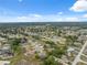 Expansive aerial view of the neighborhood, showcasing lush greenery, well-maintained homes, and blue skies at 3400 Rosebay Ct, Spring Hill, FL 34609