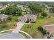 Beautiful single-story home with a brick driveway, screened-in patio, and a lush green lawn surrounded by mature trees at 3400 Rosebay Ct, Spring Hill, FL 34609