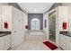 Bathroom featuring a soaking tub, glass enclosed shower, and double vanity at 3400 Rosebay Ct, Spring Hill, FL 34609