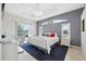 Cozy bedroom features a tray ceiling, natural light, and a private balcony, creating a tranquil retreat at 3400 Rosebay Ct, Spring Hill, FL 34609
