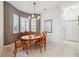 Cozy dining room features chair-rail accents and charming chandelier lighting to create a welcoming space at 3400 Rosebay Ct, Spring Hill, FL 34609