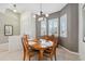 Bright dining room features elegant chandelier lighting and a bay window, creating an inviting dining space at 3400 Rosebay Ct, Spring Hill, FL 34609