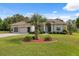 Attractive home boasting manicured landscaping, a paver driveway, and a well-kept lawn at 3400 Rosebay Ct, Spring Hill, FL 34609