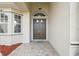 Elegant entryway highlighting a double-door entry and brick-paved walkway at 3400 Rosebay Ct, Spring Hill, FL 34609