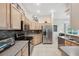 Modern kitchen with stainless steel appliances and lots of cabinet storage for organization and efficiency at 3400 Rosebay Ct, Spring Hill, FL 34609