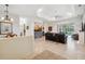 Open-concept living room with tile flooring, coffered ceiling, and views of the pool area at 3400 Rosebay Ct, Spring Hill, FL 34609