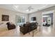 Bright living room featuring tile flooring, neutral colors, and sliding glass doors to the pool at 3400 Rosebay Ct, Spring Hill, FL 34609