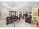 Open-concept living area with coffered ceilings seamlessly connects to the kitchen, creating a comfortable atmosphere at 3400 Rosebay Ct, Spring Hill, FL 34609
