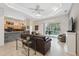 Open-concept living room with tile floors and view of pool at 3400 Rosebay Ct, Spring Hill, FL 34609