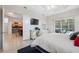 Bright main bedroom featuring a tray ceiling, desk area, and sliding doors to the pool at 3400 Rosebay Ct, Spring Hill, FL 34609