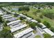 Panoramic view of the condo community nestled amongst lush trees, a lake, and a golf course at 3544 Teeside Dr # 1, New Port Richey, FL 34655