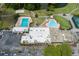 Overhead view of community with pools, clubhouse, parking and access to a pond at 3544 Teeside Dr # 1, New Port Richey, FL 34655