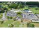 Expansive aerial view of the community clubhouse with pool, tennis courts, parking and meticulously maintained golf course at 3544 Teeside Dr # 1, New Port Richey, FL 34655